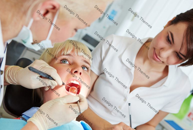 a dentist examining teeth of a woman patient