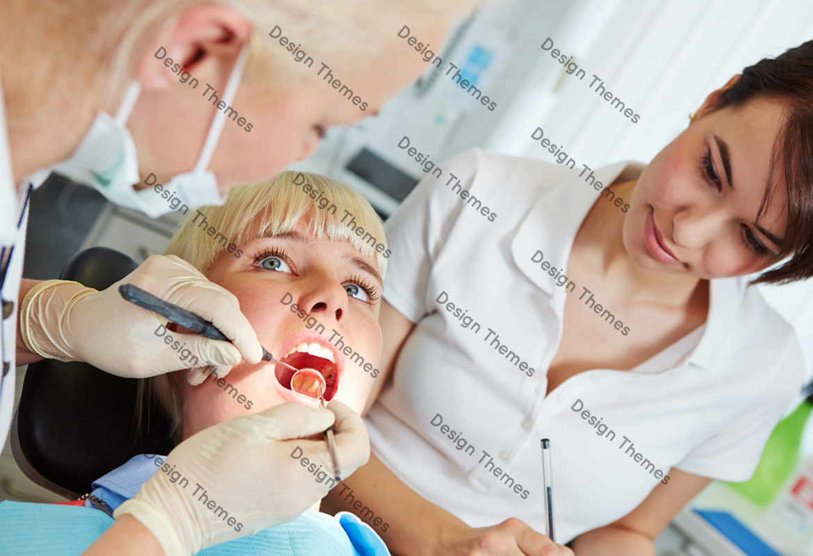 a dentist examining teeth of a woman patient