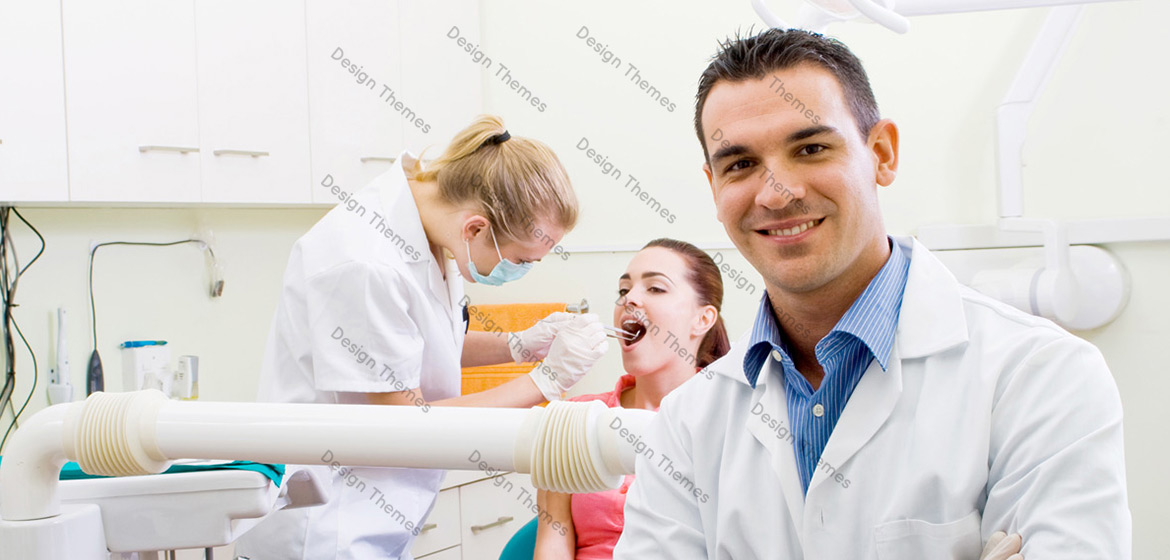 Closeup of a male dentist and a patient in the background