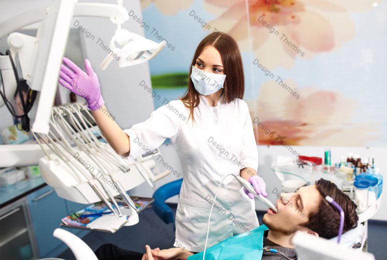 a woman dentist and a patient looking at a screen